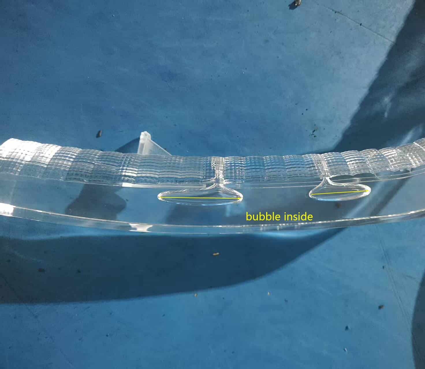 Internal bubble inside thick wall transparent PC injection molded part caused by center shrinkage